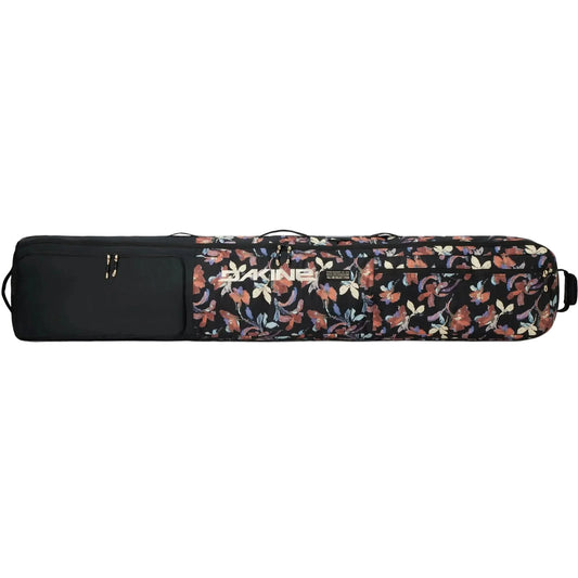 A Dakine ski bag with a black body, featuring a floral pattern on the front in shades of orange, beige, and blue, with a black padded end cap and a silver logo.